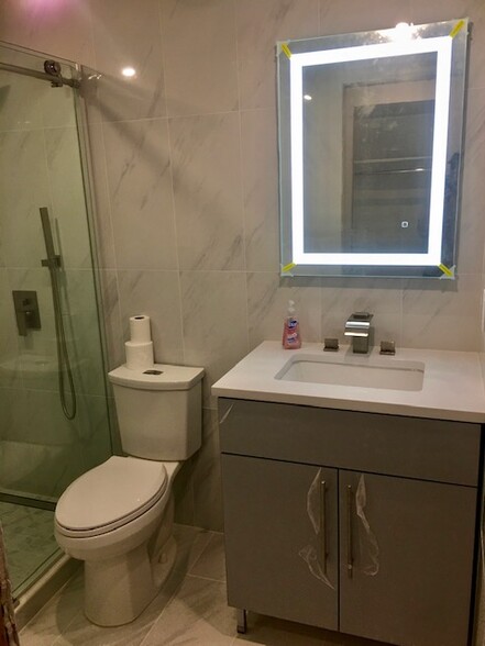 Bathroom with lighted mirror and vanity - 700 Schuyler Ave