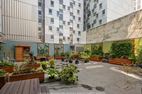 Building Photo - Charming Condo with Rooftop Garden and Com...