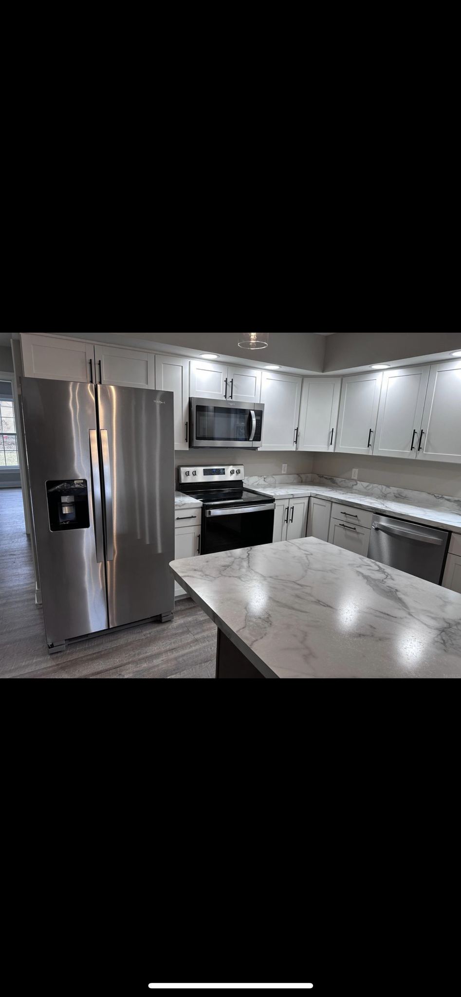 Kitchen with aisle and high-end top brands stainless steel appliances - 713 E Powell Ave