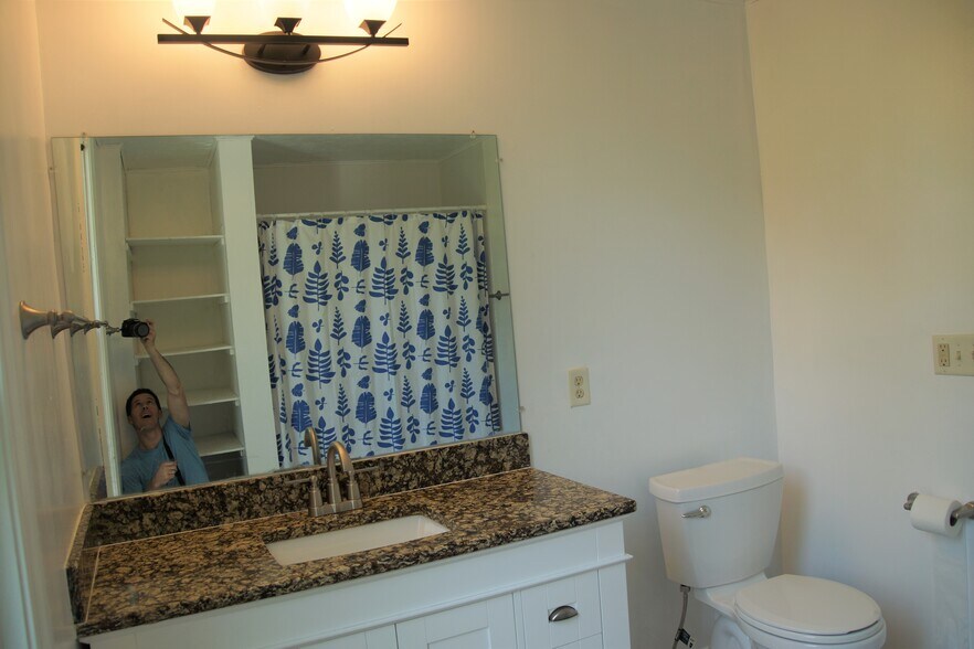 Full bathroom off of kitchen with storage. - 1020 Burns Ave