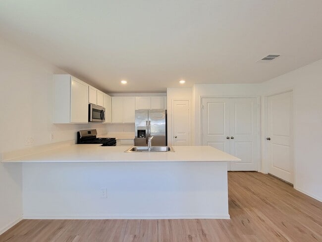 Building Photo - This single-story home has a comfortable layout with three bedrooms and a living area all on one ...