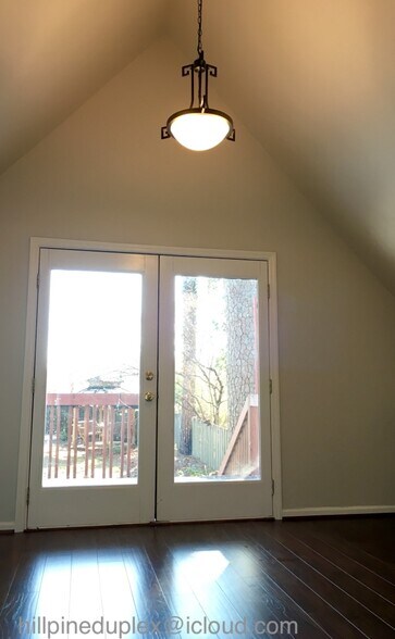 Dining room off kitchen with vaulted ceiling. French doors open onto wood deck. - 629 Hillpine Dr NE