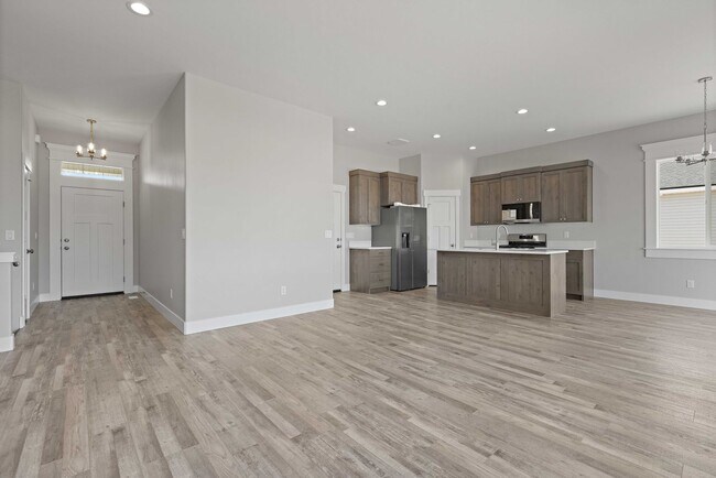 Building Photo - NEW HOME with large garage stalls and unfinished basement for additional storage