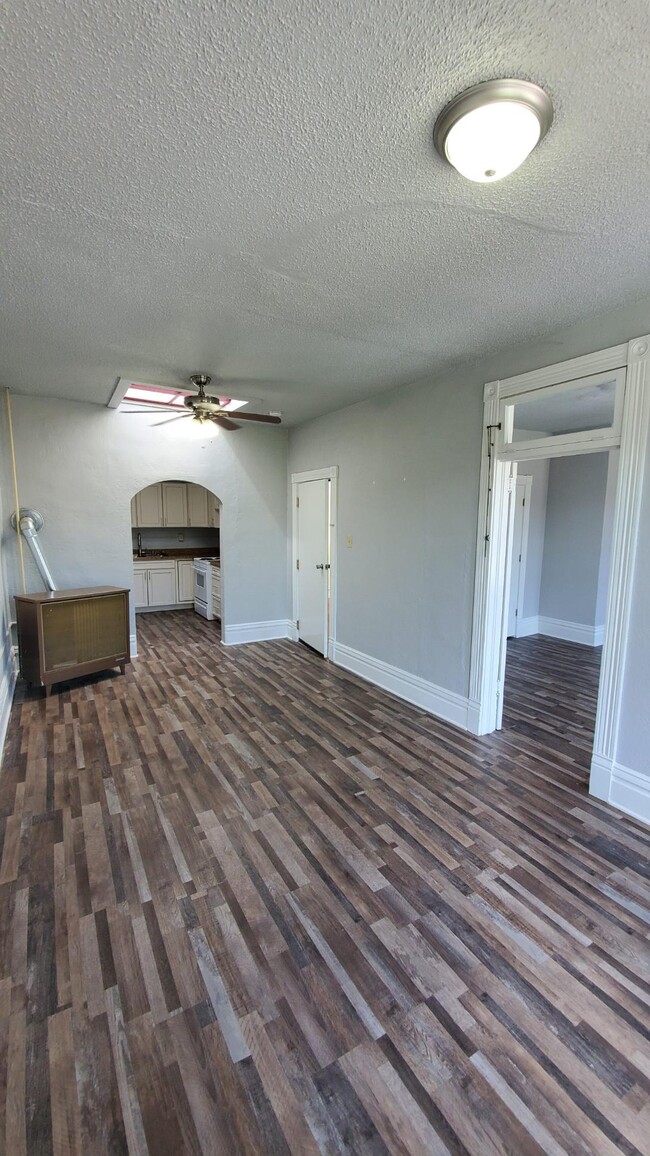 Living room looking into the kitchen, bedroom to the right - 116 W Main St