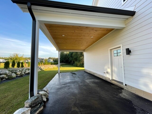 Covered parking area with entrance - 70 Bardwell St