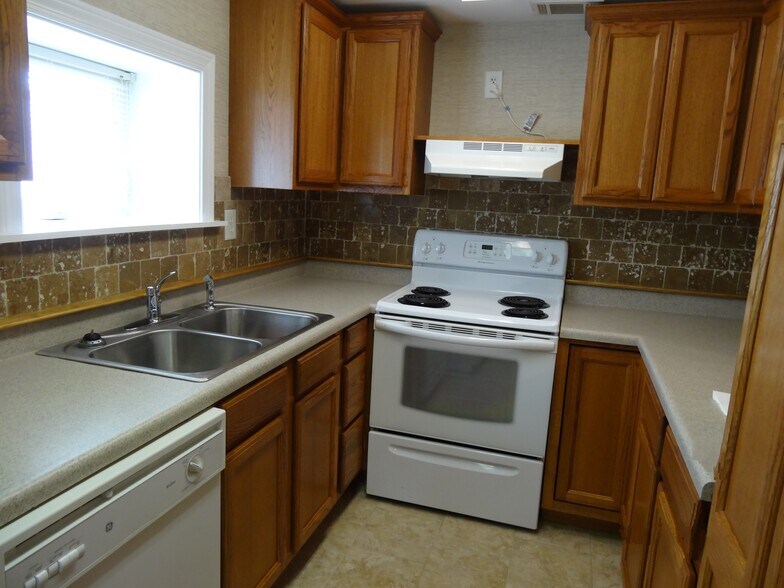 Kitchen has spacious cabinet storage and room for microwave over the stove - 512 Macon Hwy