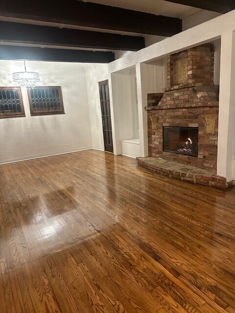 Beautiful living room with two leaded windows and wood beam ceiling - 367 Beloit Ave
