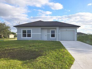 Building Photo - Brand-New 2/2/1 -SW Lehigh Acres-See this ...