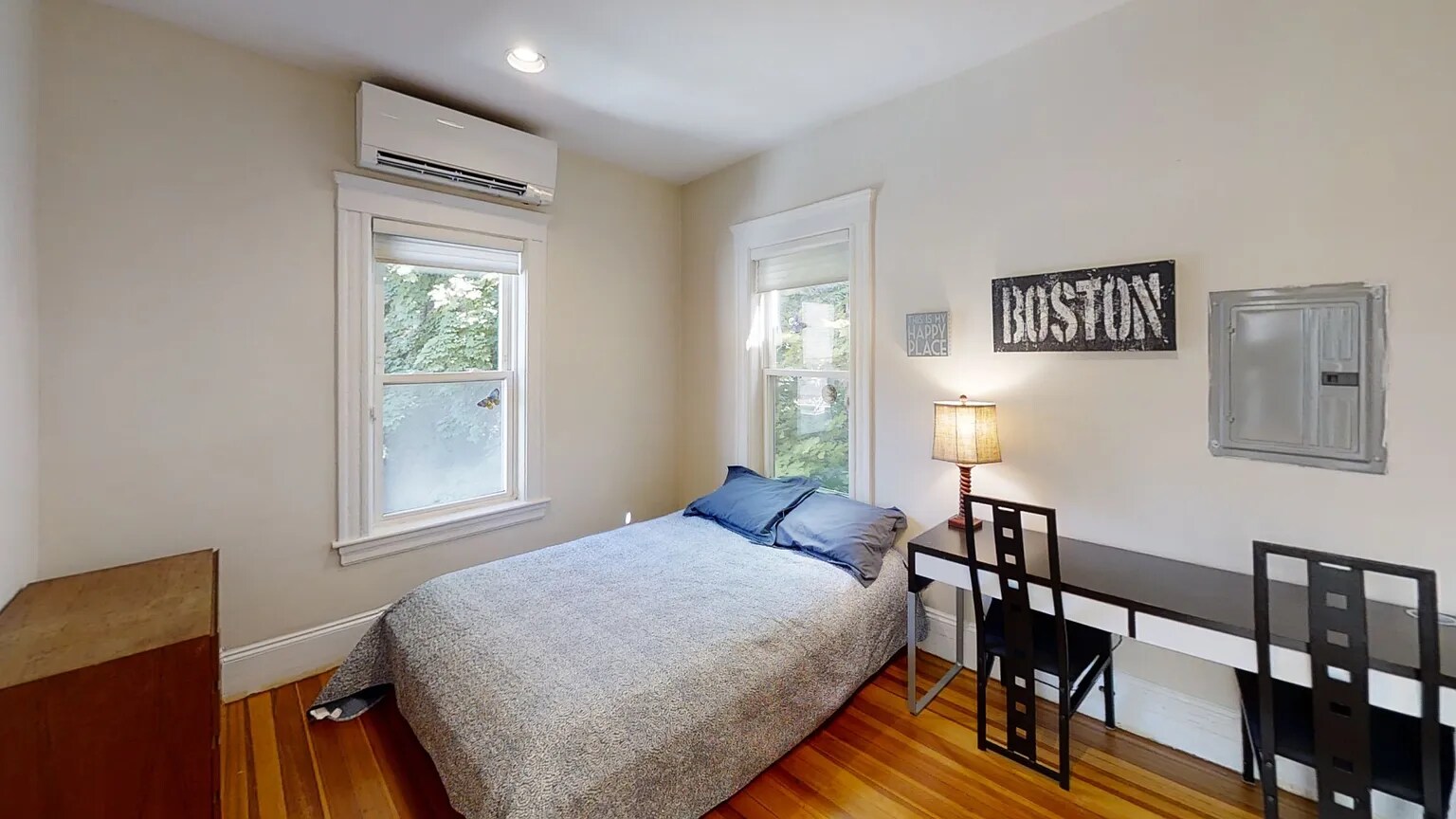 Bedroom #3 pre-repairs with two large windows facing back yard. - 307 Tappan St