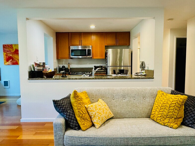 Sleek, fully equipped kitchen w granite countertops, stainless steel appliances, & wood cabinets - 2145 Dexter Ave N