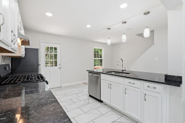 Building Photo - Experience contemporary living in this beautifully renovated residence where modern design meets ...