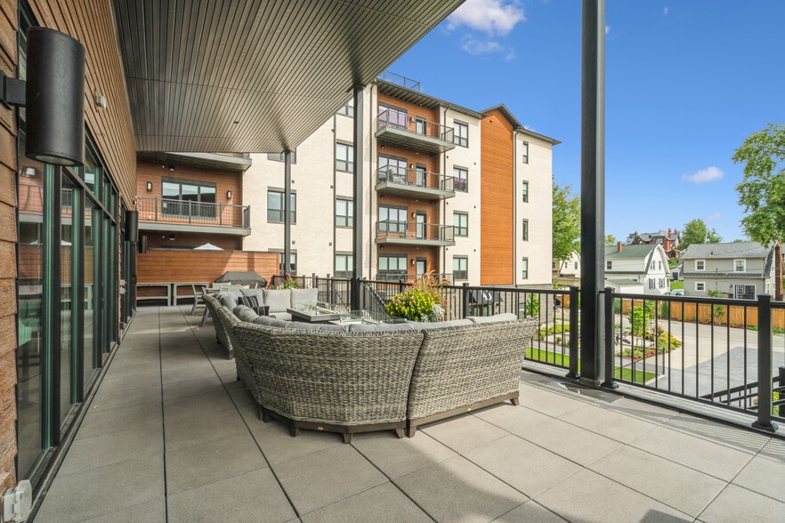 Spacious outdoor seating on balcony of building with fire tables - 1953 1st Ave SE