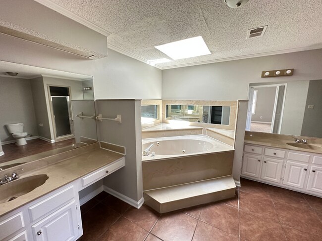 Building Photo - Grand 4BR/2BA Near Southwind | 2,438 Sq Ft, Stone Fireplace, Soaking Tub & 2-Car Garage