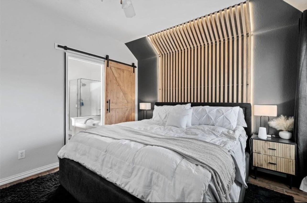 Primary bedroom with designer wall treatment - 2109 Castle Creek Dr